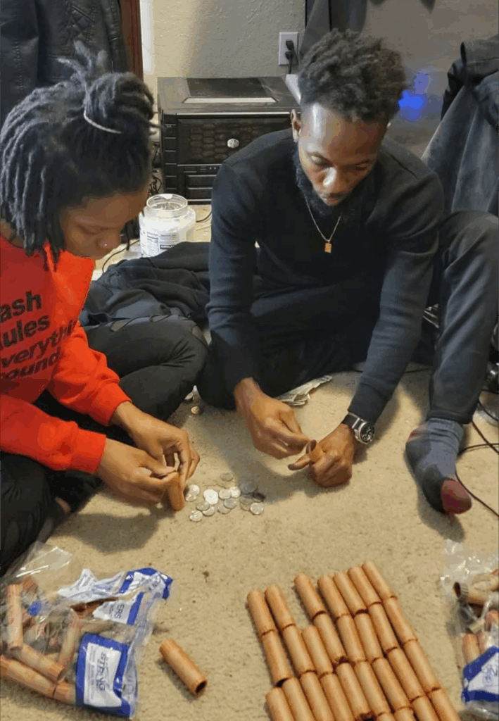 Jalal Wilson and his wife rolling coins on the floor during a financially difficult season in Columbia, SC
